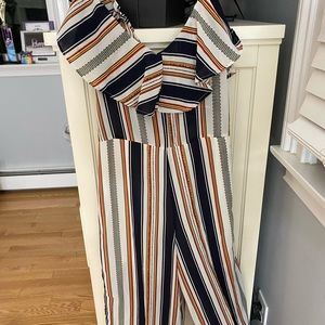 red, white, orange, yellow, blue stripped jumpsuit